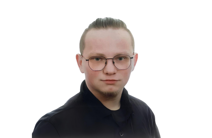 The photo of the article's author - back-end developer at Primotly. The picture shows a professional young man with short hair and glasses looks directly at the camera. 