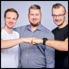 Three smiling software developers